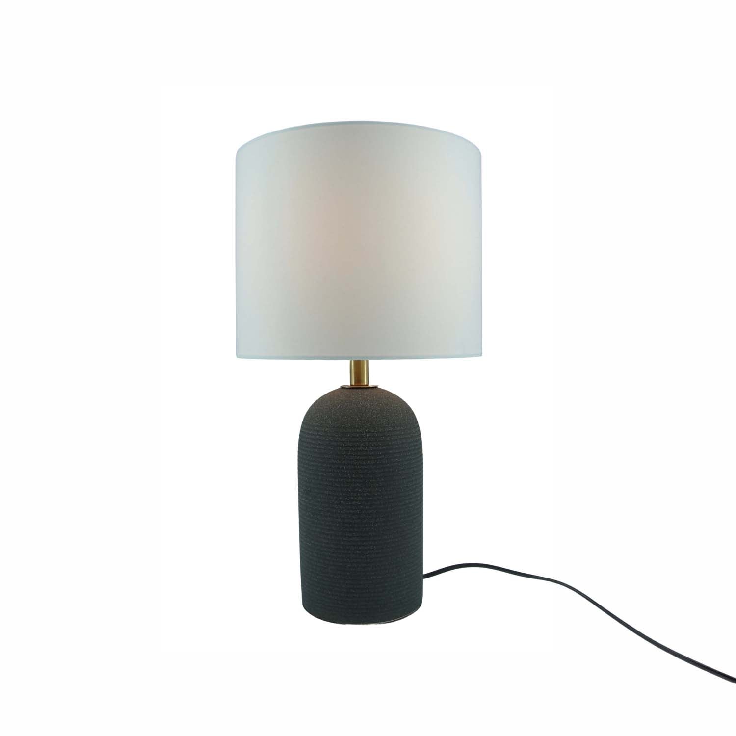 A modern table lamp with a textured dark cylindrical base, a gold-finished neck, and a white drum shade, shown on a plain white background with its power cord visible.