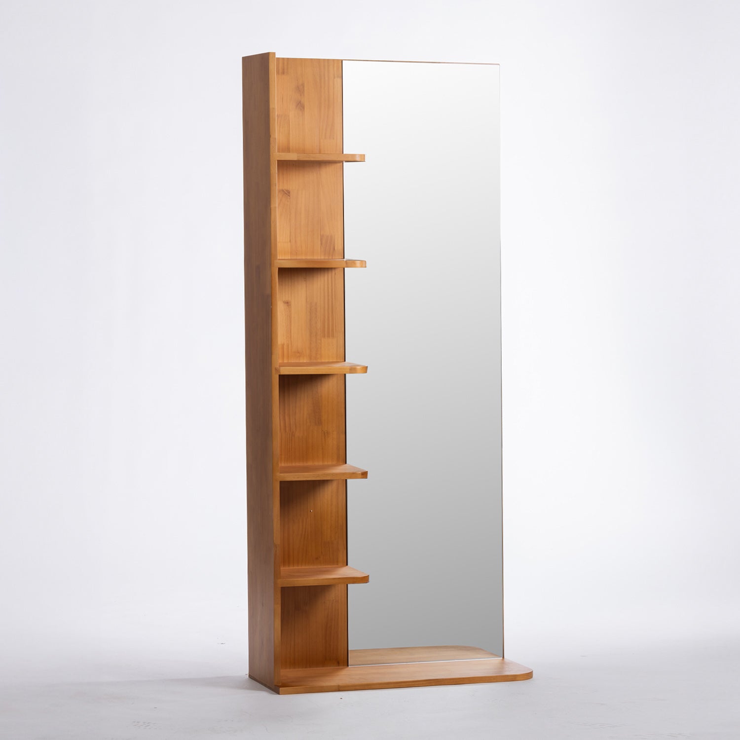 A modern wall-mounted mirror with an integrated wooden shelving unit on the left side, featuring five open shelves in a warm medium-brown wood finish against a plain white background.