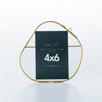 Gold metal floating frame with a black label on a white background