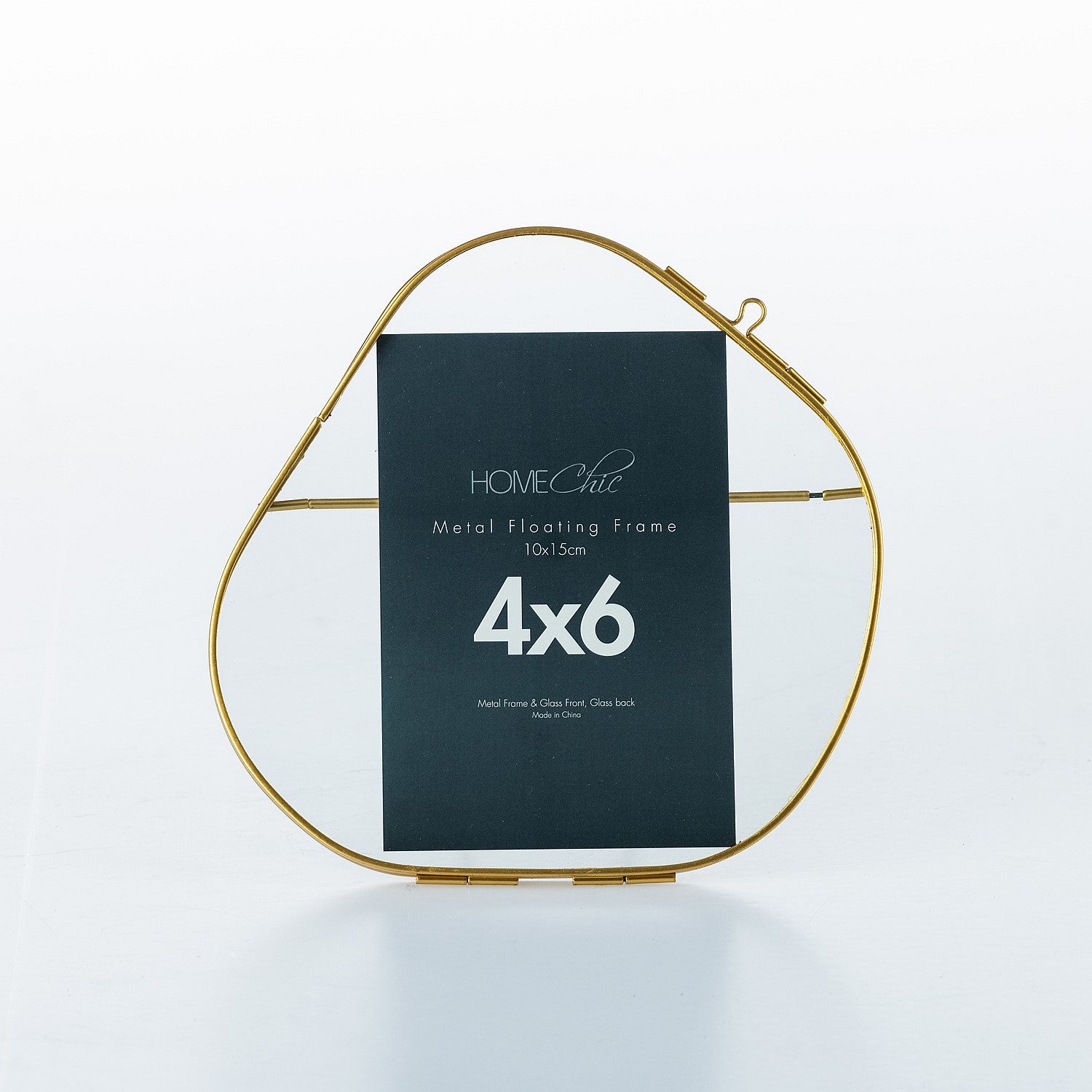 Gold metal floating frame with a black label on a white background