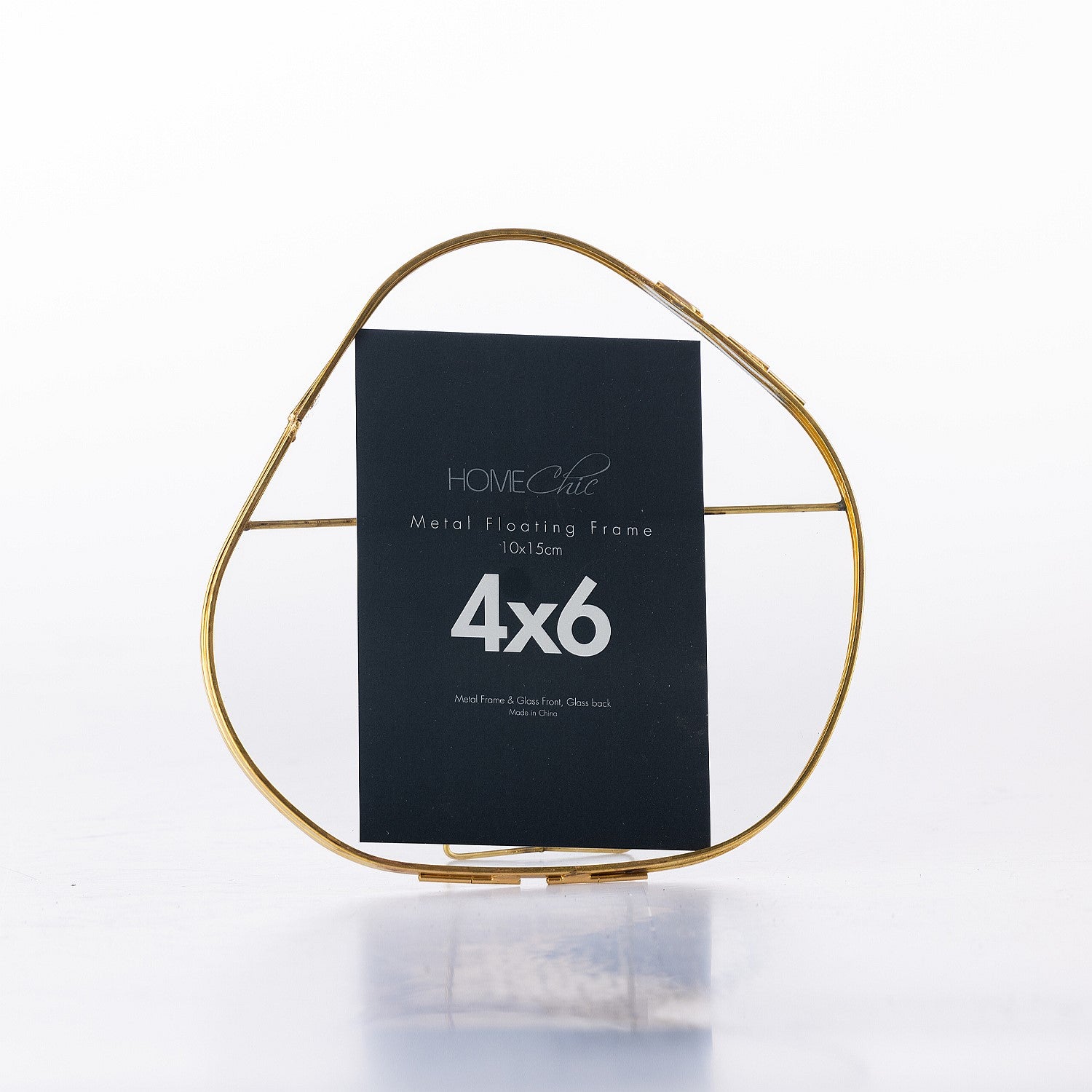 Gold metal floating frame with a black label on a white background
