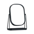 Black tabletop vanity mirror with a rounded rectangular frame, tilting stand, and integrated storage tray.