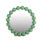 Round green bobble mirror featuring glossy spherical detailing around the edge and a plain mirrored centre, shown against a white background.