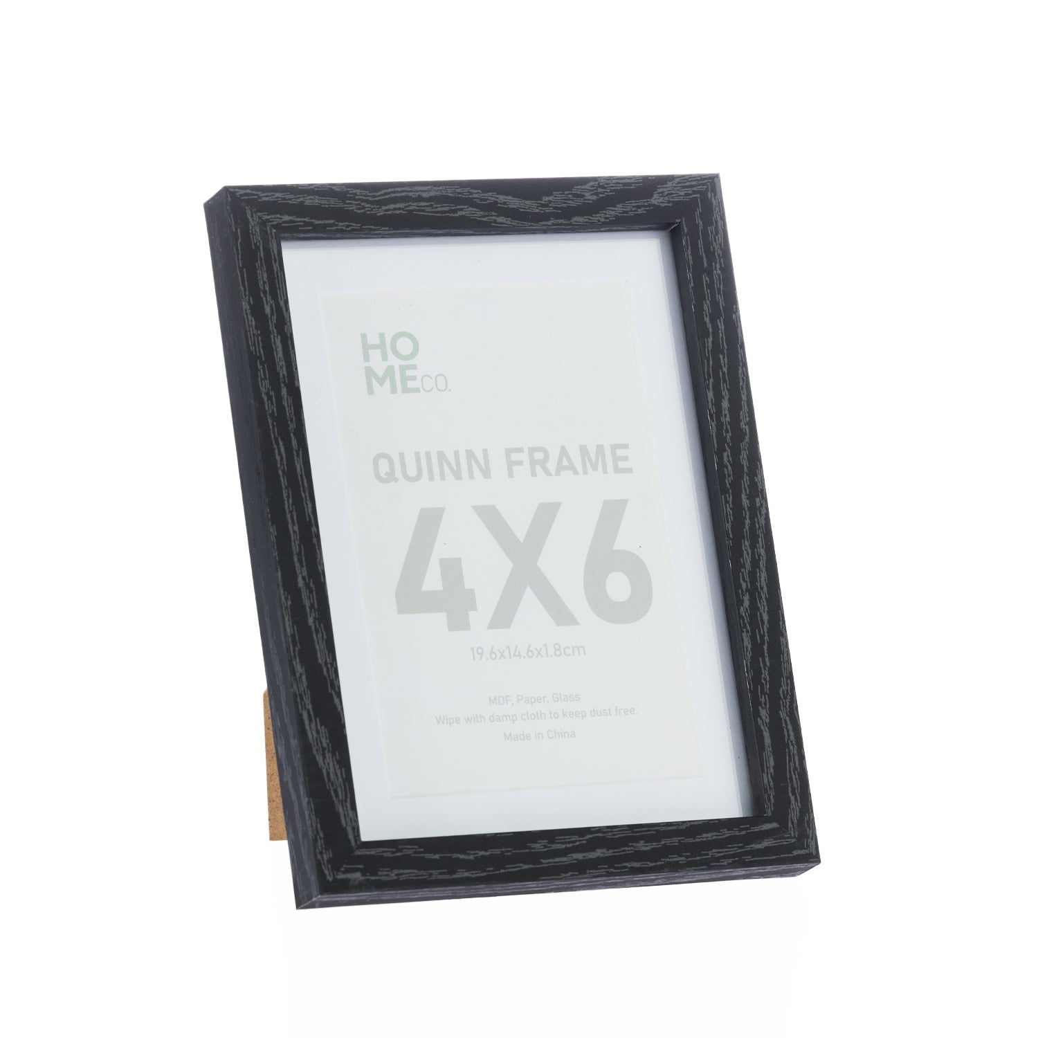 A black woodgrain 4×6 photo frame with a white mat and glass front is displayed on a stand against a plain light background.