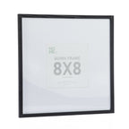A black woodgrain 8×8-inch square photo frame with a wide white mat is displayed against a plain light background, highlighting its clean, contemporary design.
