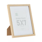 A natural wood-look 5 × 7 photo frame with a wide white mat and subtle timber grain finish provides a timeless way to display your favourite photographs or prints.