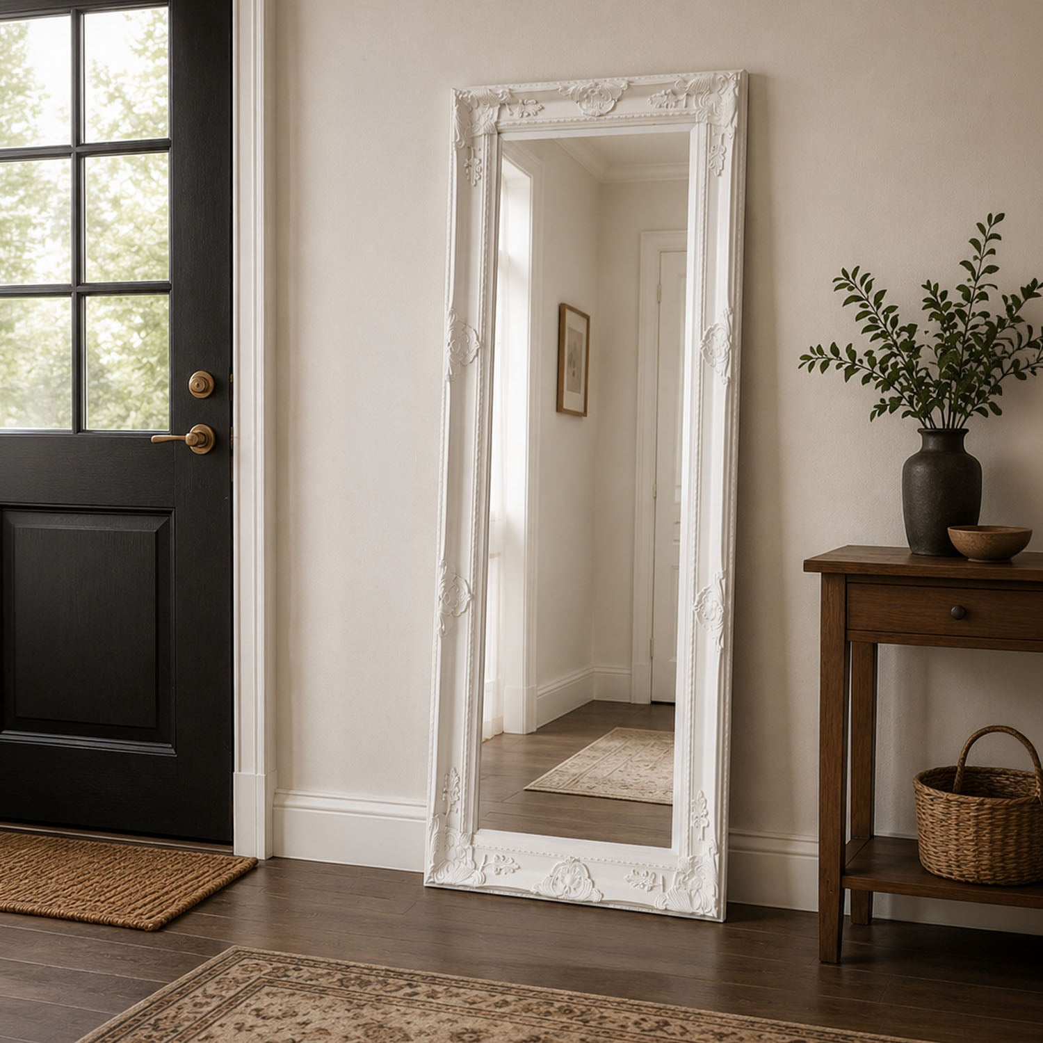 White Mayfair Bevelled Leaner Mirror styled in an entryway, featuring an ornate carved frame with decorative detailing and a full-length reflective mirror surface.