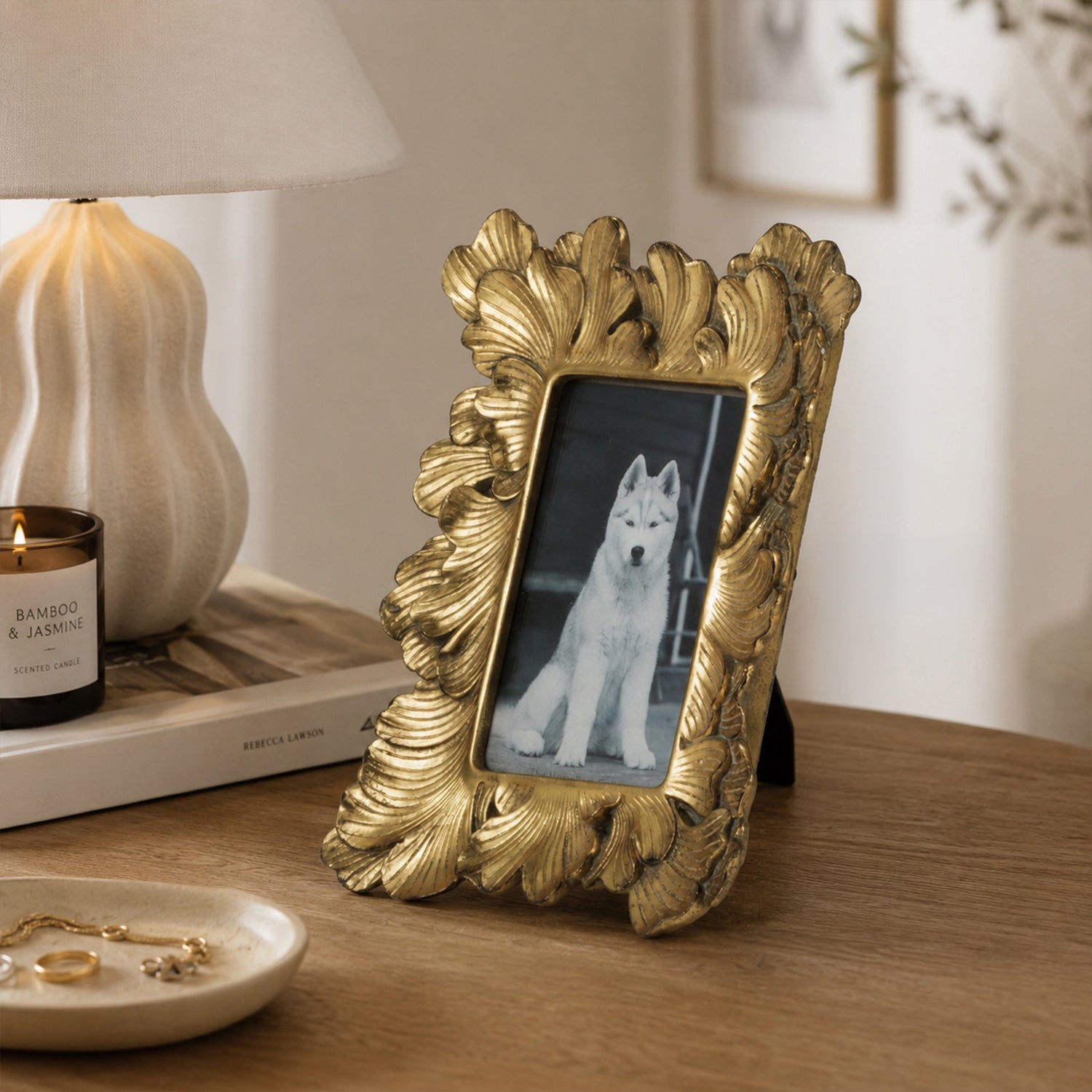 Design Republique Duchess Small Gold Photo Frame styled on a wooden console table with a lamp, candle and decorative accessories in a warm, elegant interior setting.