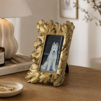 Design Republique Duchess Small Gold Photo Frame styled on a wooden console table with a lamp, candle and decorative accessories in a warm, elegant interior setting.