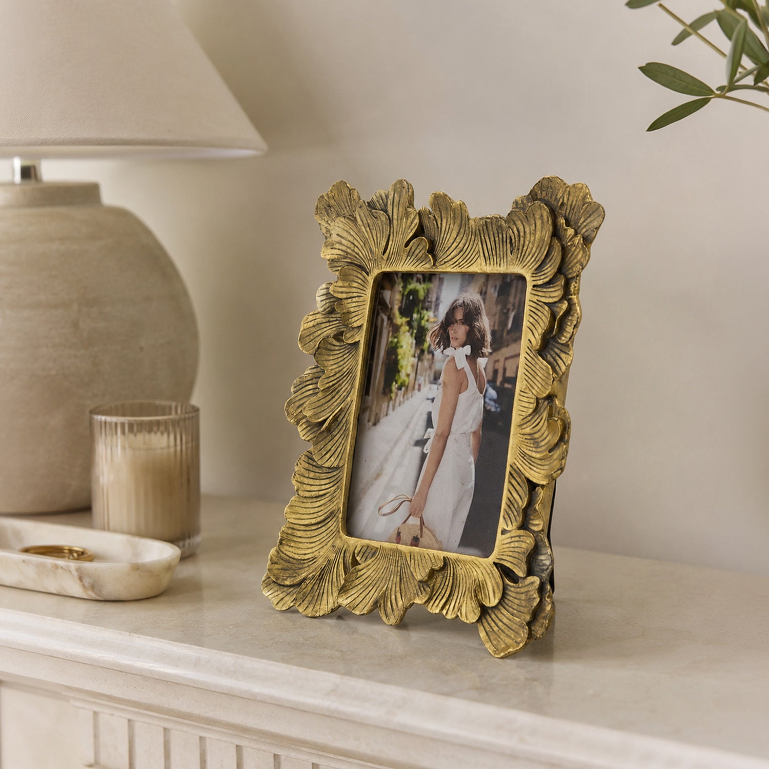 Design Republique Duchess Large Gold Photo Frame styled on a console table with a ceramic lamp, candle and decorative accents in a warm, elegant interior setting.