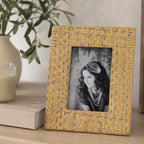 Design Republique Ella Natural Photo Frame styled on a wooden console table with books, a candle and ceramic vase in a warm, natural home setting.