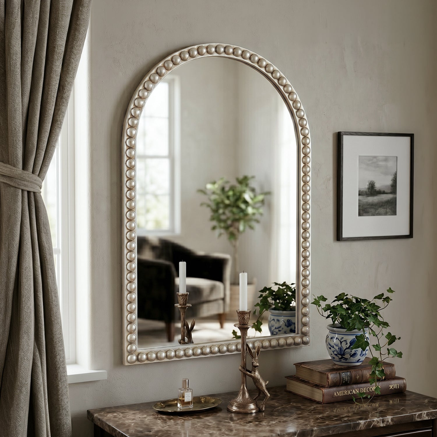 Cove knotted arched mirror displayed above a console table in a neutral interior setting.