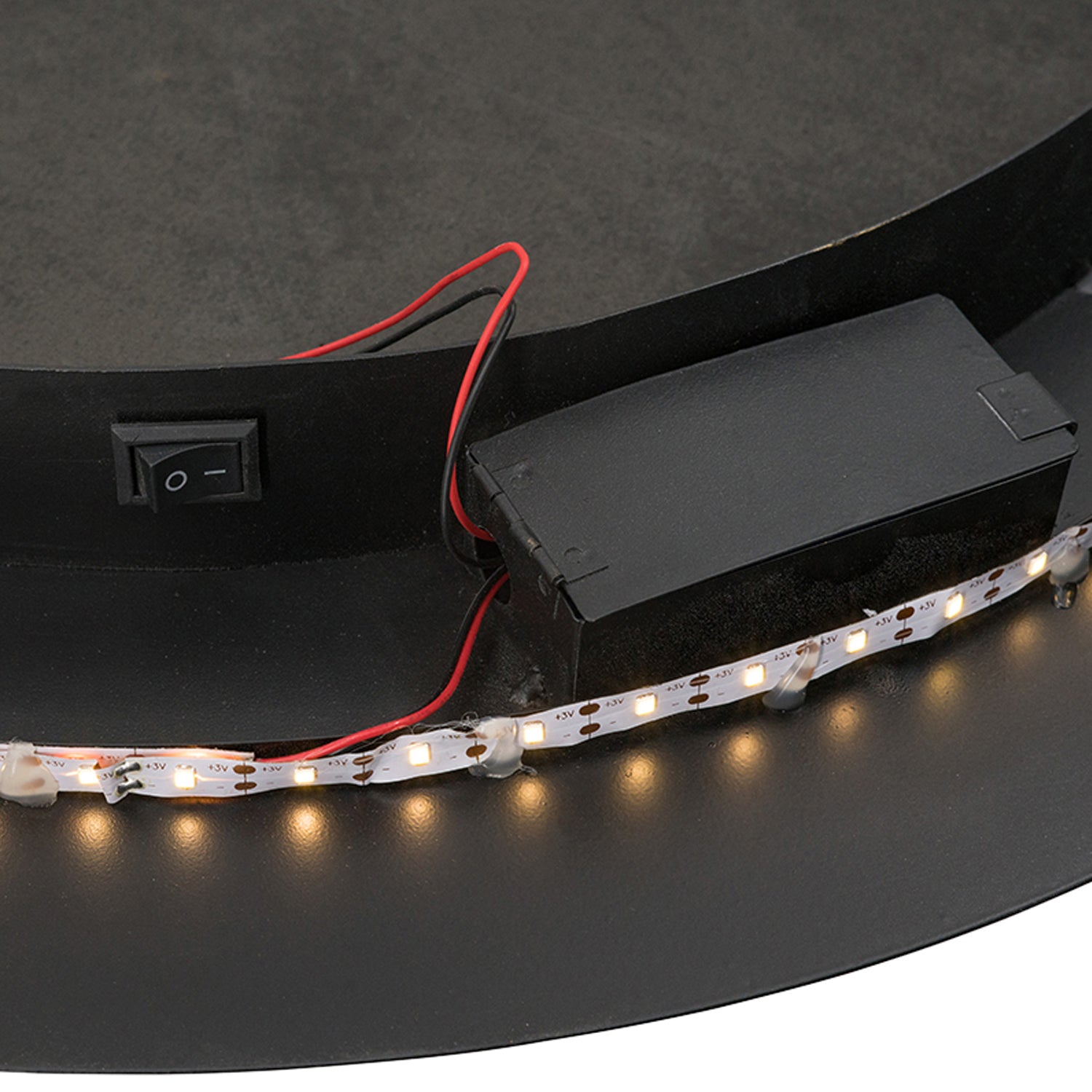 Close-up of the back of the Design Plus Leona LED Mirror showing the battery compartment, wiring, LED strip and on/off switch.