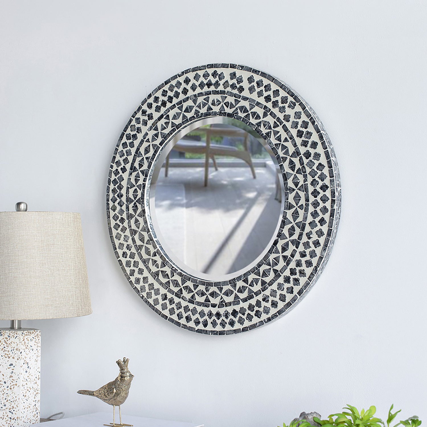 Design Republique Algaia round wall mirror displayed on a white wall, featuring a grey and white geometric mosaic-style frame.