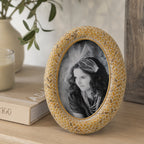 Design Republique Ella Natural Oval Photo Frame styled on a wooden console table with books, a candle and ceramic vase in a warm, natural home setting.