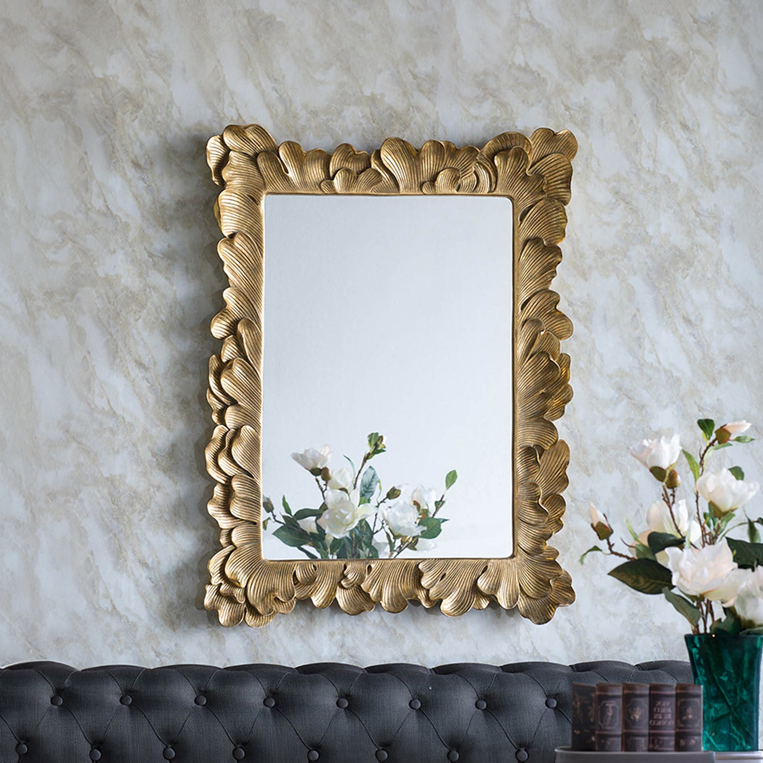 Gracious Living Duchess Mirror displayed on a wall in a styled interior, showing its detailed antique gold floral frame above a dark upholstered sofa.