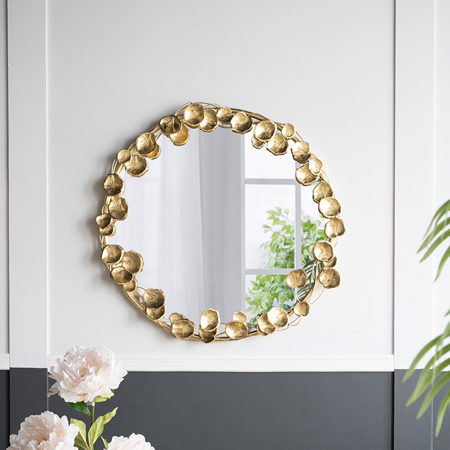 Gracious Living Gold Leaf Mirror mounted on a two-tone wall in a styled room with flowers, greenery and neutral furnishings.