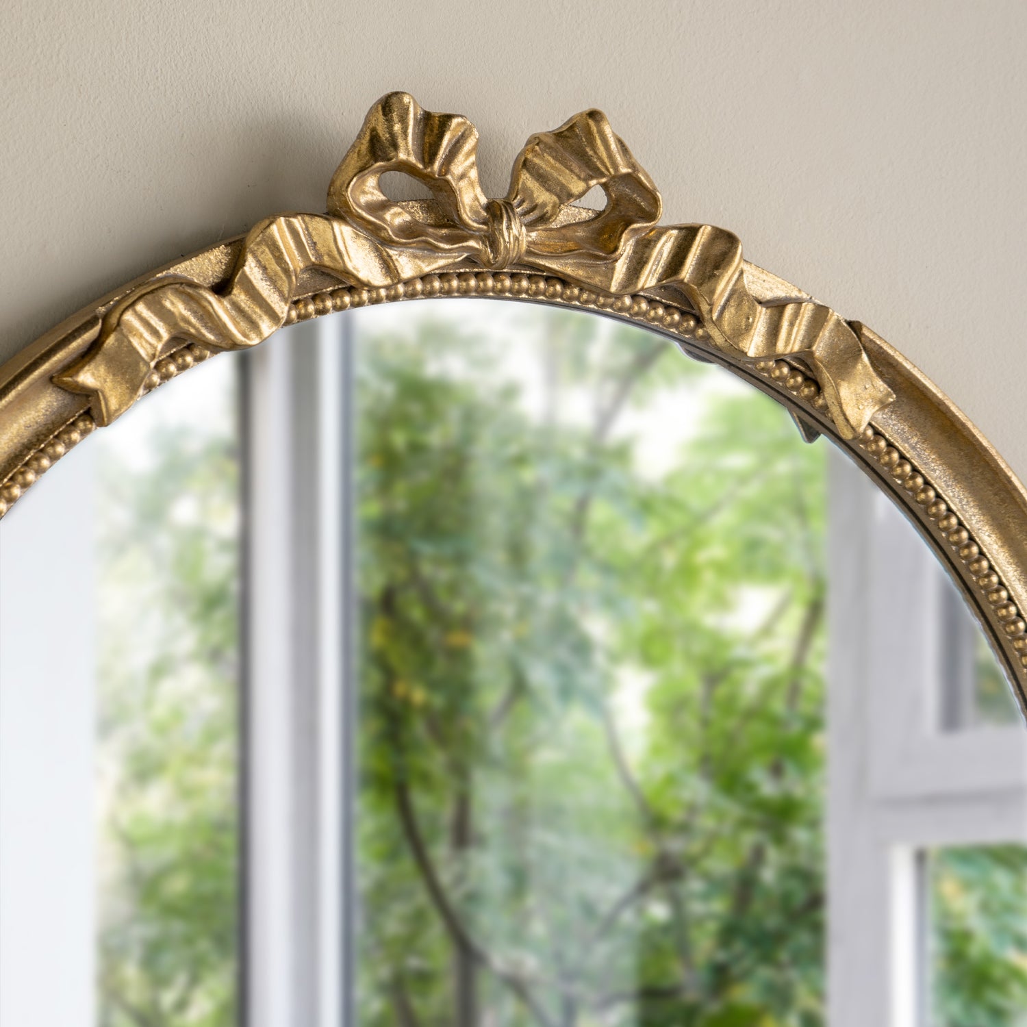 Close-up of the Gracious Living Bella Bow Mirror highlighting the sculpted bow, ribbon detailing and beaded inner border.