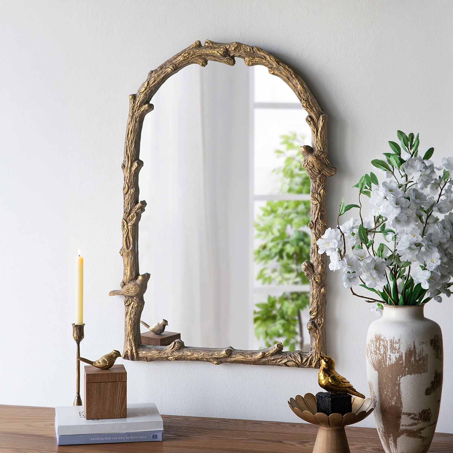 Gracious Living Birds Arched Mirror displayed on a wall above a console with floral and bird-inspired decorative accents.