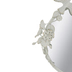 Close-up of the Gracious Living Birds & Flowers Round Mirror highlighting the sculpted white birds, flowers and leaves with subtle gold-toned accents.