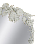 Close-up of the Gracious Living Birds & Flowers Round Mirror highlighting the white sculpted flowers, leaves, bird and hanging tassel details with subtle gold-toned accents.