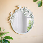 Gracious Living Birds & Flowers Round Mirror displayed on a warm neutral wall, featuring decorative white birds, flowers and leaves around the circular mirror.