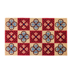 A striking coir doormat features a bold checkerboard design with vibrant floral tile motifs in rich red, blue and natural tones, creating a colourful and welcoming entrance.