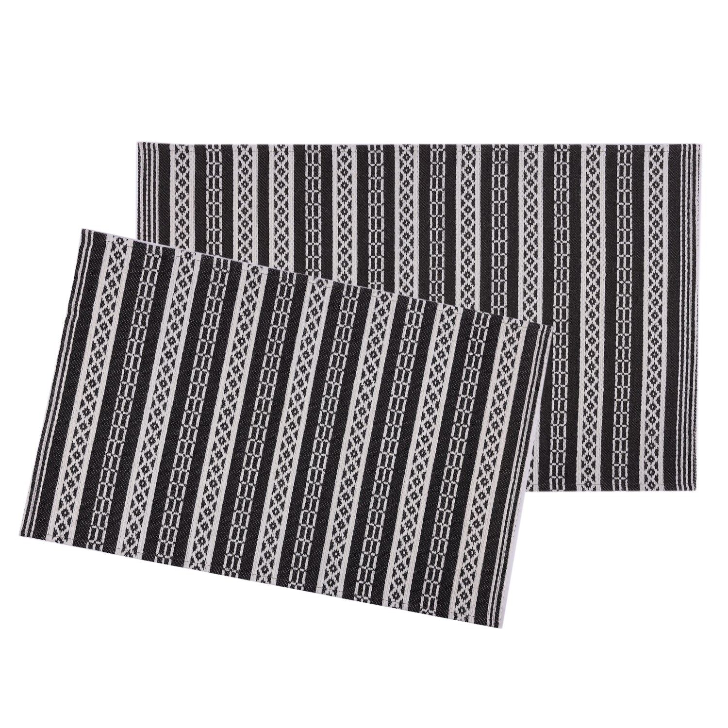 Two rectangular placemats with a black, white, and gray geometric striped pattern, displayed overlapping on a solid white background.
