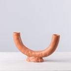 Ceramic vase with a unique design on a white surface and light gray background