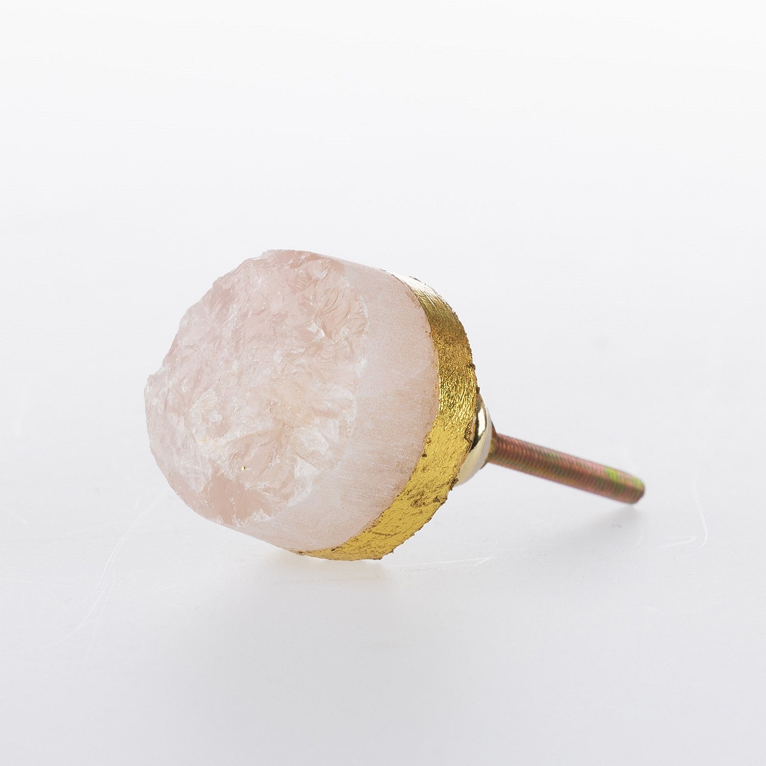 Rose quartz crystal drawer knob with natural rough-cut stone finish, gold-tone edging and metal screw fitting.
