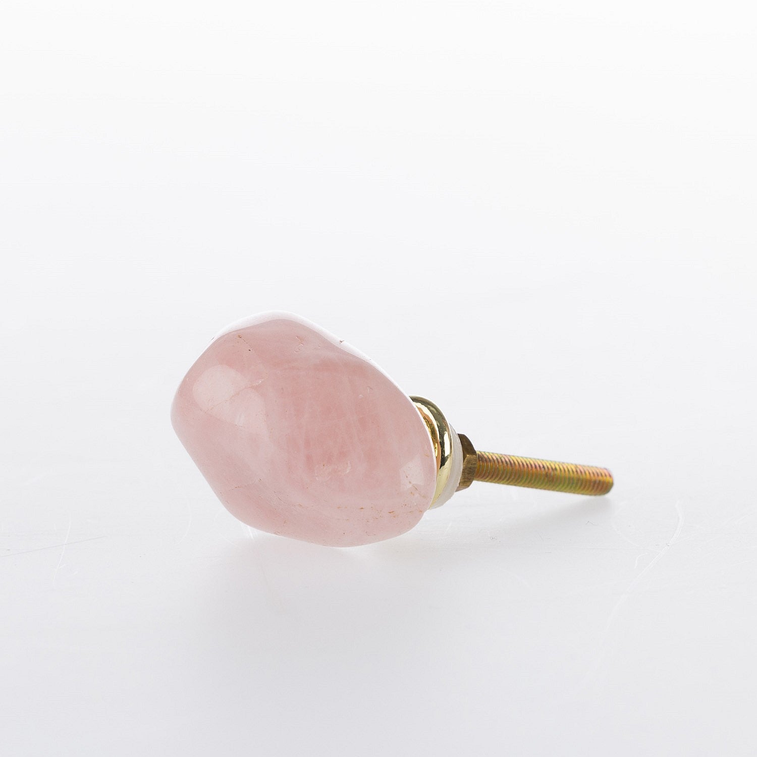 Rose quartz stone drawer knob with a polished pink finish and gold-tone metal fitting.