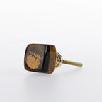 Brown tiger's eye stone drawer knob with polished natural finish and gold-tone metal fitting.

