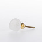 White stone drawer knob with a smooth polished finish and gold-tone metal fitting.