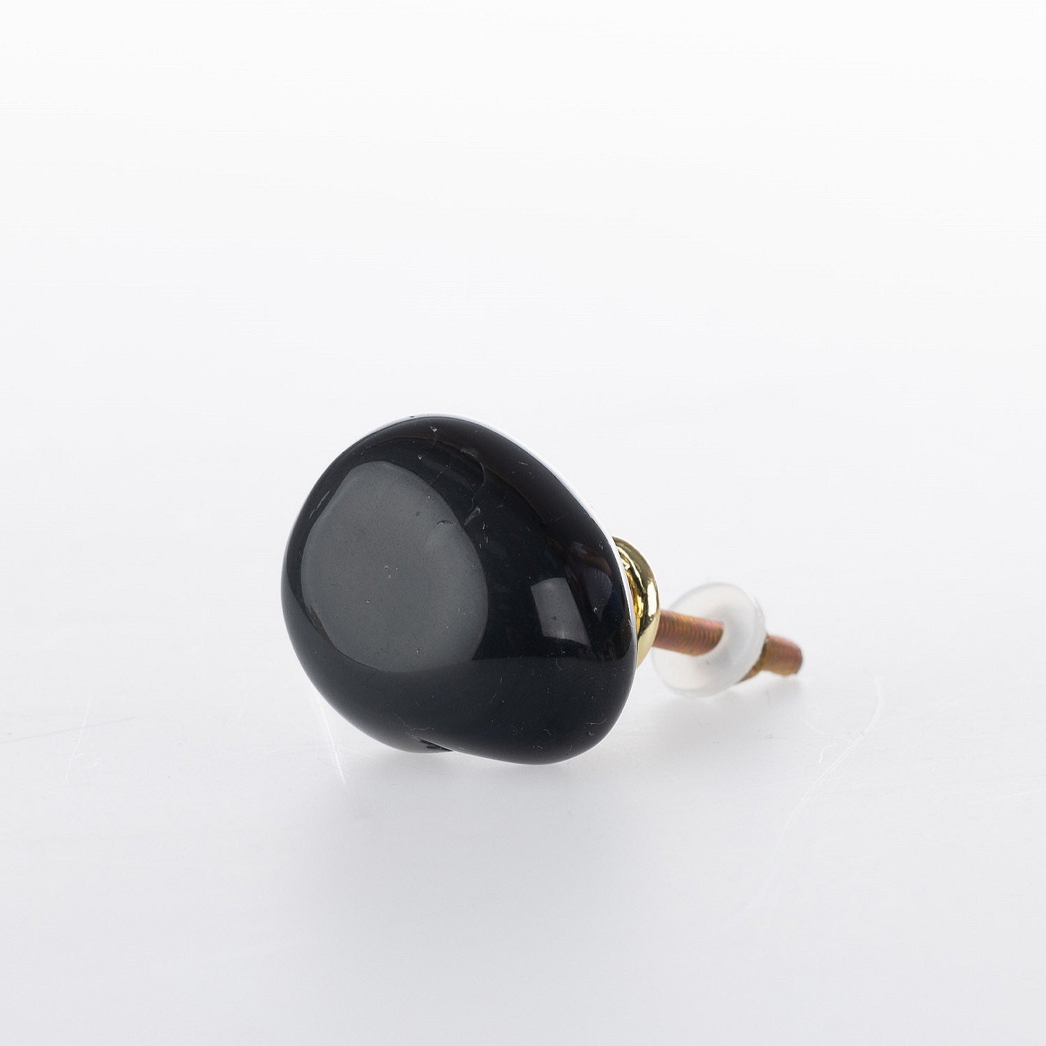Black obsisidan polished stone drawer knob with smooth organic shape and gold-tone metal fitting.