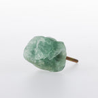 Green rough-cut crystal drawer knob with a natural stone finish and metal screw fitting.