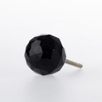 Black faceted glass drawer knob with a jewel-inspired design and silver-tone metal fitting.