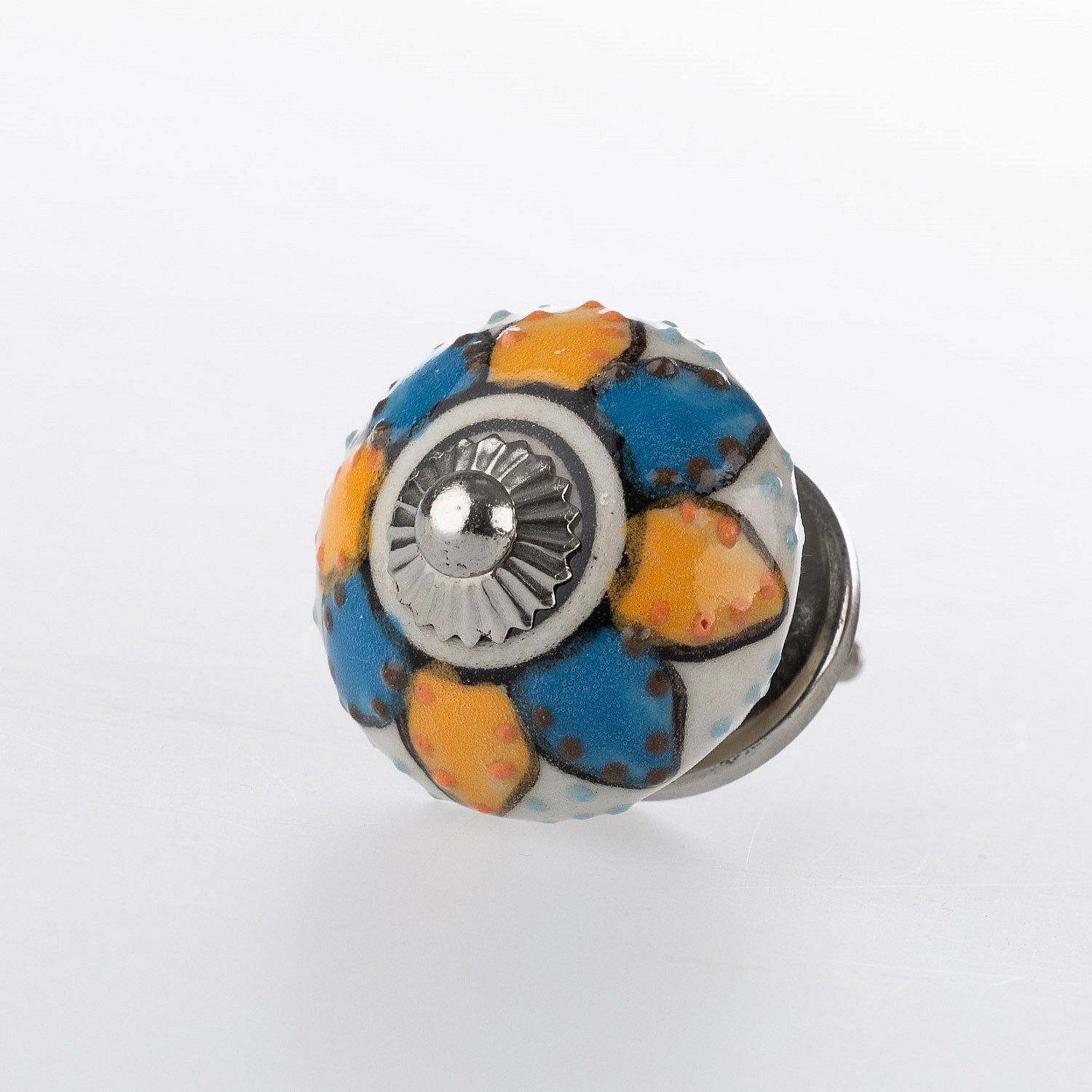 Round ceramic drawer knob with a blue, yellow and white floral pattern and silver-tone metal centre accent.