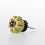 Green flower-shaped ceramic drawer knob with bronze-tone centre detail, metallic gold stripe accents and a glossy finish.
