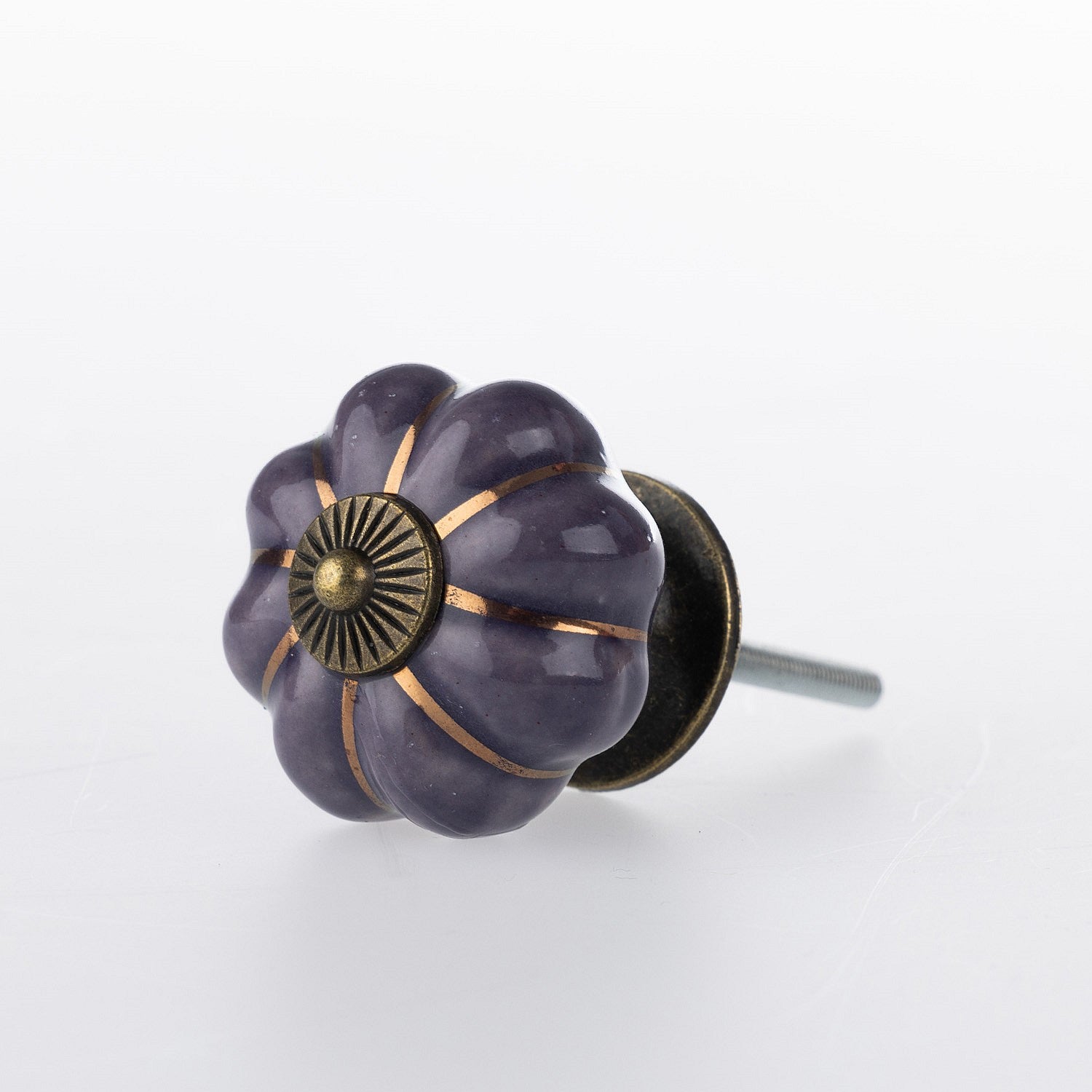 Purple flower-shaped ceramic drawer knob with bronze-tone centre detail, metallic gold stripe accents and a glossy finish.
