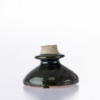 Close-up of the Design Republique Atene Candle Holder showing the glossy dark ceramic finish and rustic textured rim.
