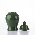 A glossy dark green ceramic jar with a matching lid, shown on a clean white background.