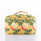 Large quilted floral toiletry bag in a mustard yellow print with top handle and zip closure.