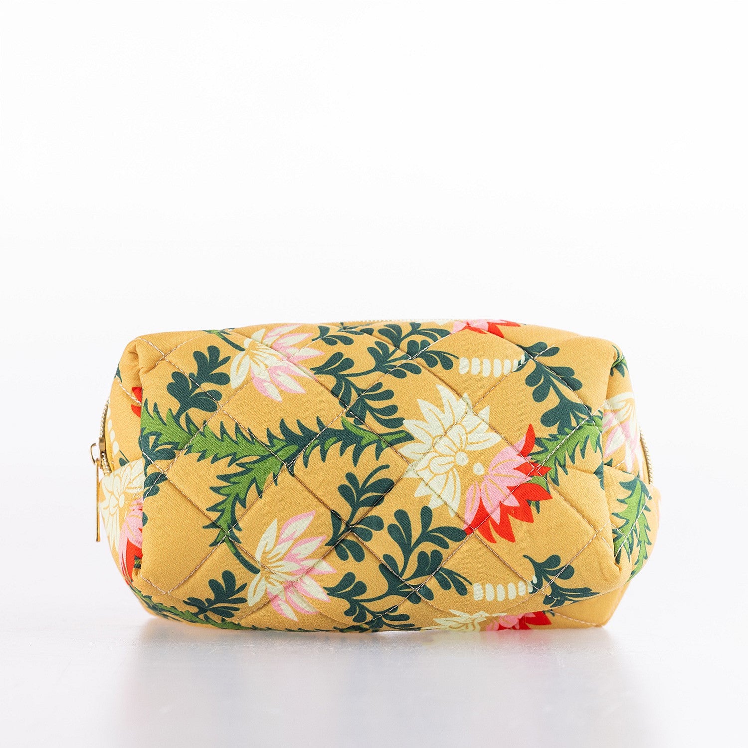 Quilted floral cosmetic bag in a mustard yellow print with zip closure and structured shape.