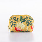 Small quilted floral cosmetic pouch with zip closure in a mustard yellow print.