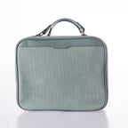 Blue woven-look vanity case with structured design, carry handle, and zip closure on a white background.
