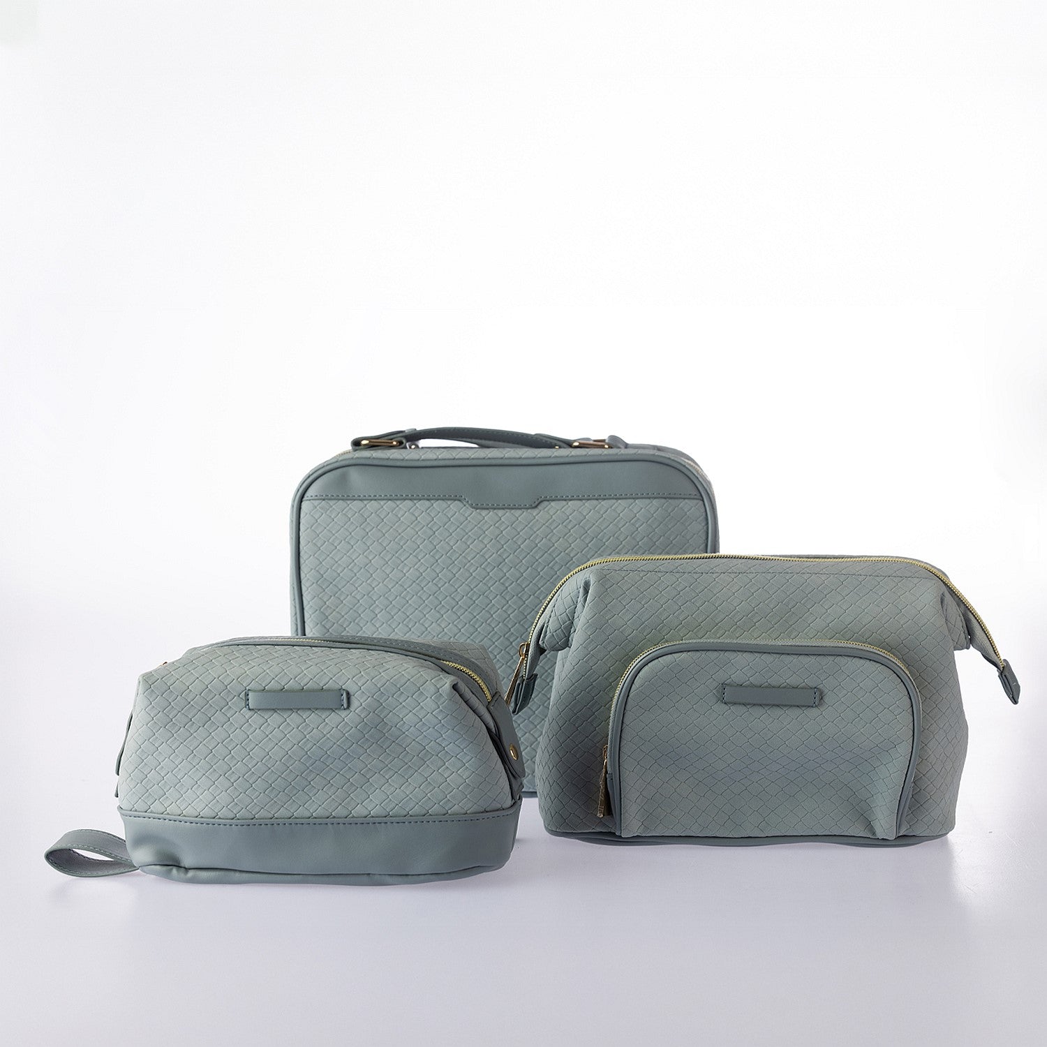 Coordinating blue woven-look cosmetic and vanity bag set with textured finish, zip closures, and gold hardware on a white background.