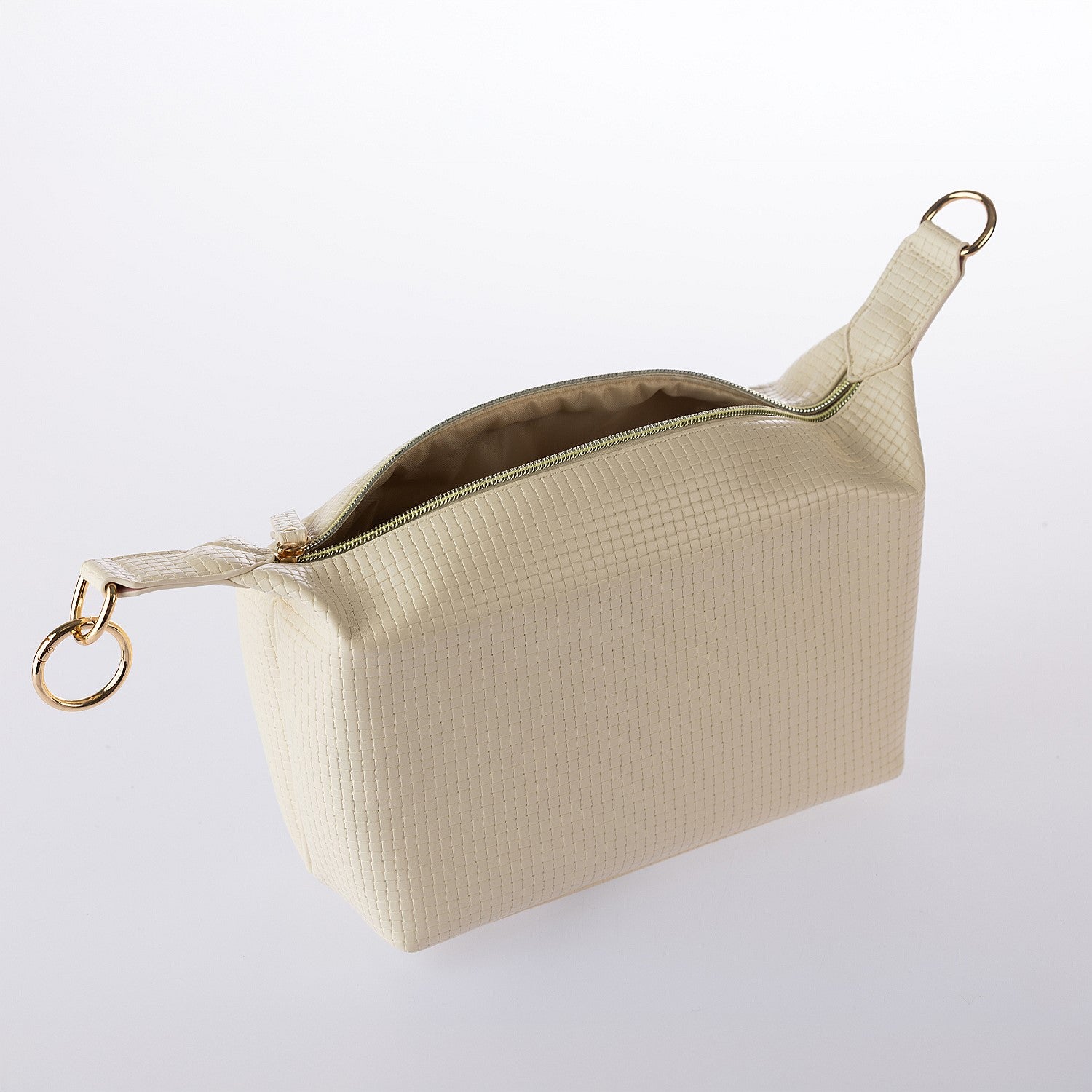 Cream textured cosmetic pouch with gold zip detailing and open top design on a white background.