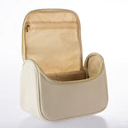 Open cream vanity case featuring spacious interior storage and internal zip pocket on a white background.