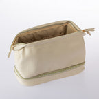 Open cream textured cosmetic organiser bag with spacious lined interior and lower storage compartment on a white background.