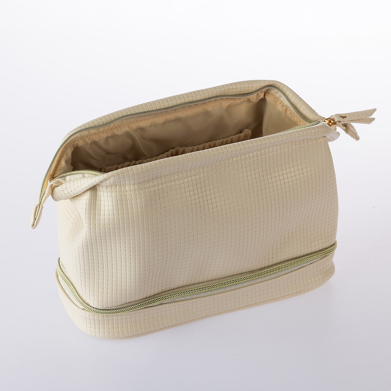 Open cream textured cosmetic organiser bag with spacious lined interior and lower storage compartment on a white background.